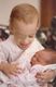 Veronique (17 months) is holding Regina (4 days).